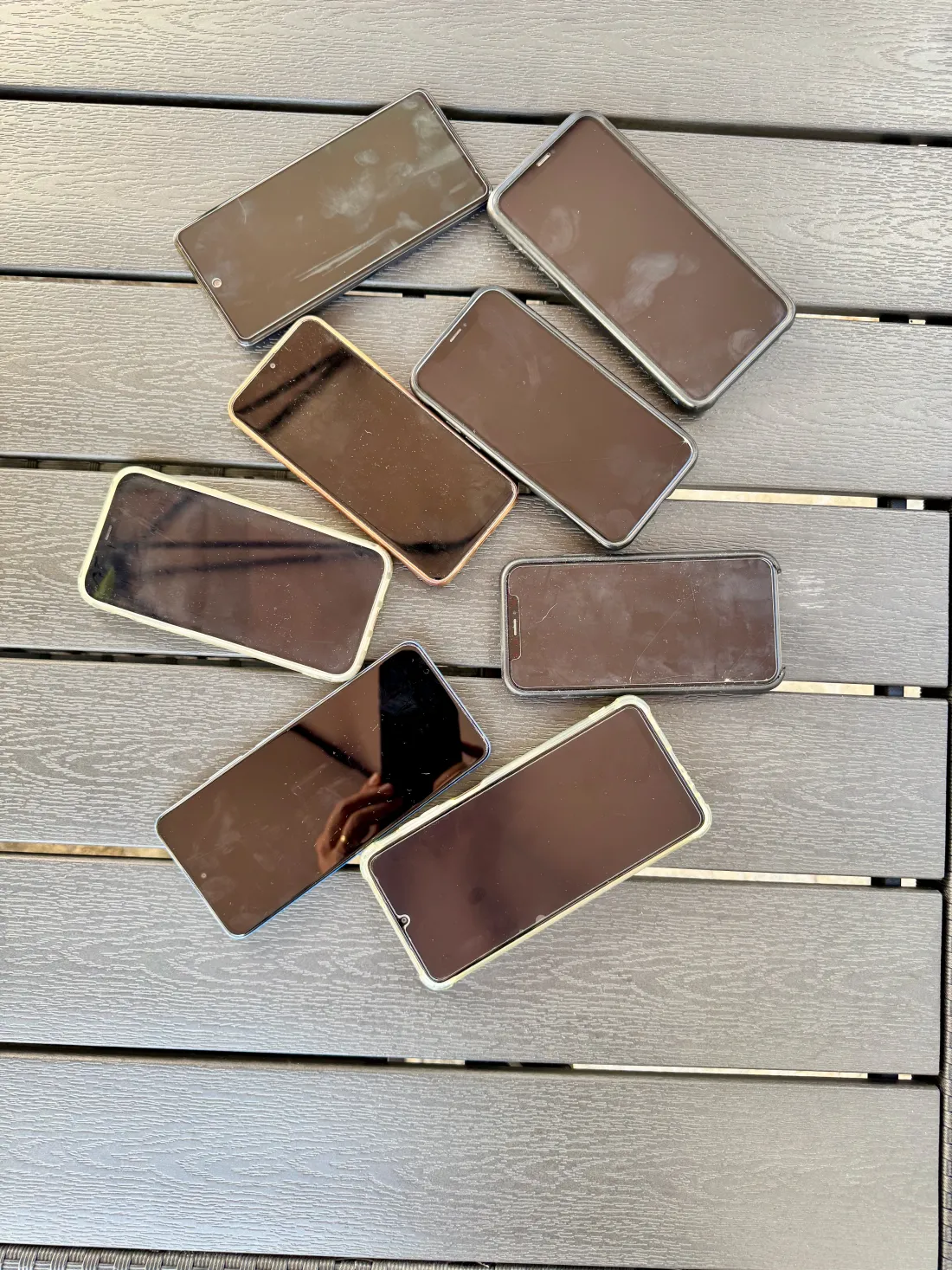 A collection of the iPhone and Android phones OffTrail is tested on, laid out together.