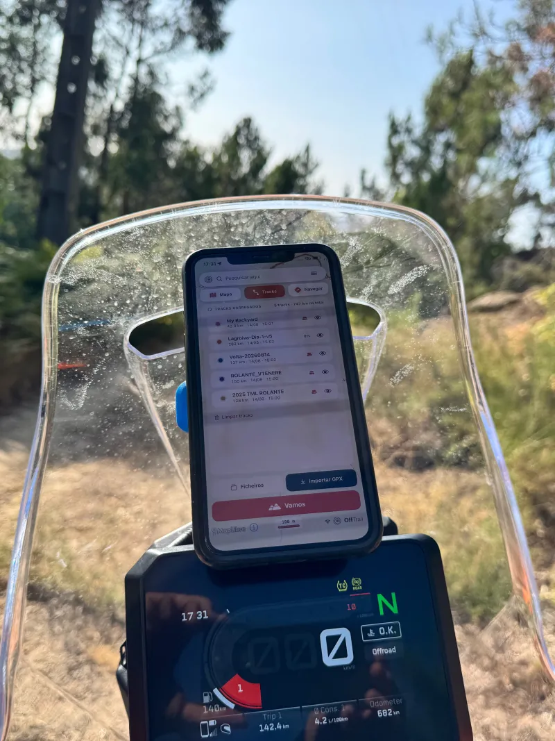 A phone mounted in portrait orientation on a motorcycle, showing OffTrail with more of the route visible ahead.